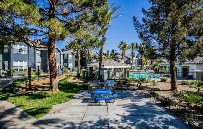 A sunny day at a residential complex with a pool and a playground.