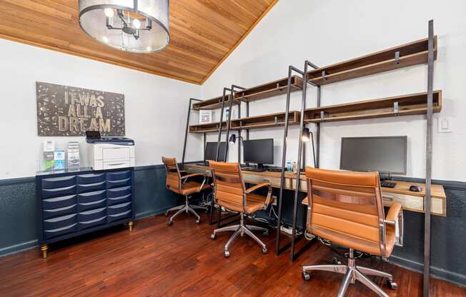 a study room with desks and chairs and a bunk bed