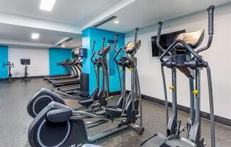 a gym with various exercise equipment in a room