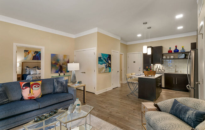 a living room and kitchen with a couch and a glass table at Aster Apartments, Ohio, 44122