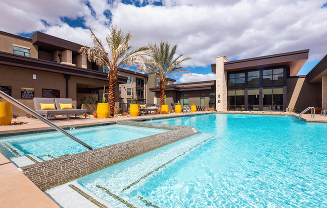pool area with trees in the background at escape at arrowhead's apartments in glendale, az