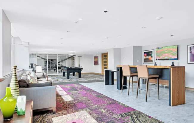 a living room with a bar and a table with chairs