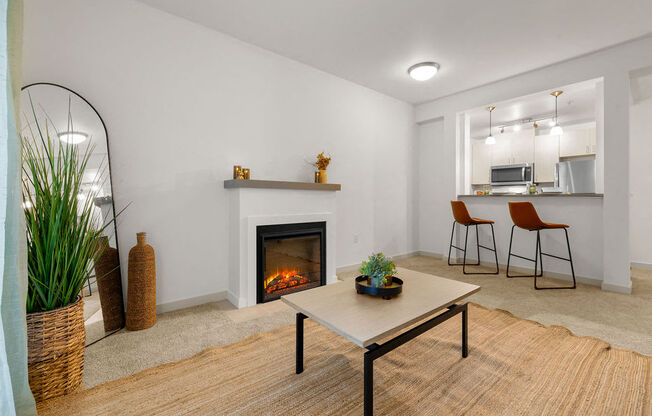 a living room with a fireplace and a table