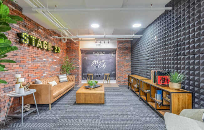 A modern living room with a brick wall and a stage 12 sign.