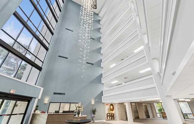 A modern interior with a chandelier and a view of the sky through the windows at Hampton Apartments, Clearwater, Florida