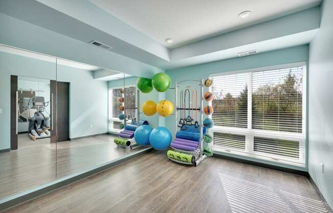 a workout room with a bunch of balloons and a window