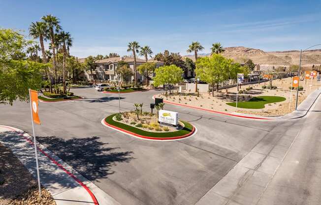 a street with an intersection and palm trees and houses