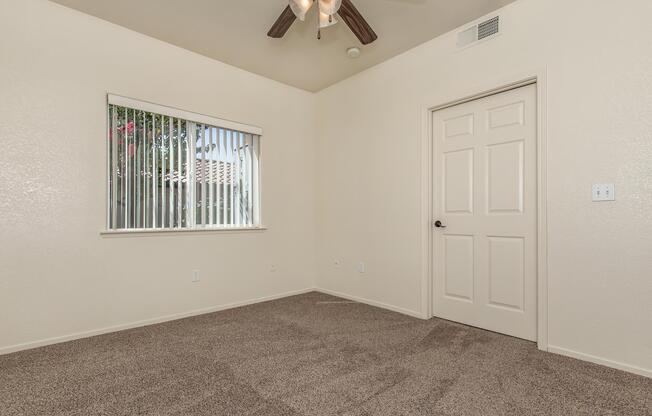 a bedroom with a bed and a mirror