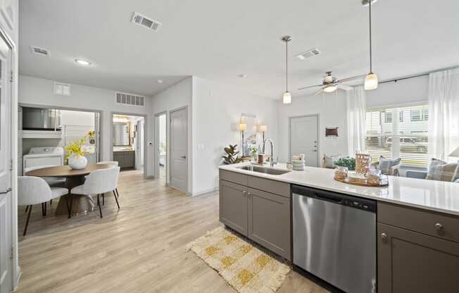 an open kitchen and living room with a table and chairs