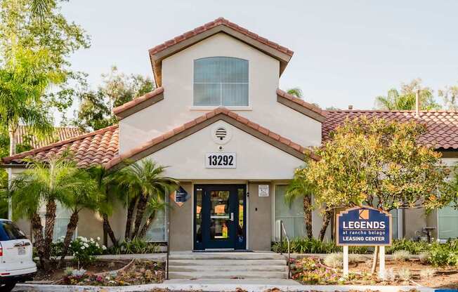 A building with a sign that says "Legends Leasing Center" in front of it.