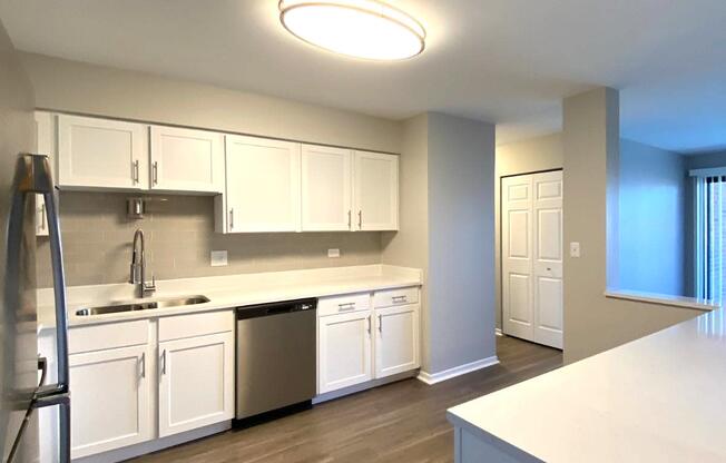 White cabinets with glass backsplash, update lighting and faucets