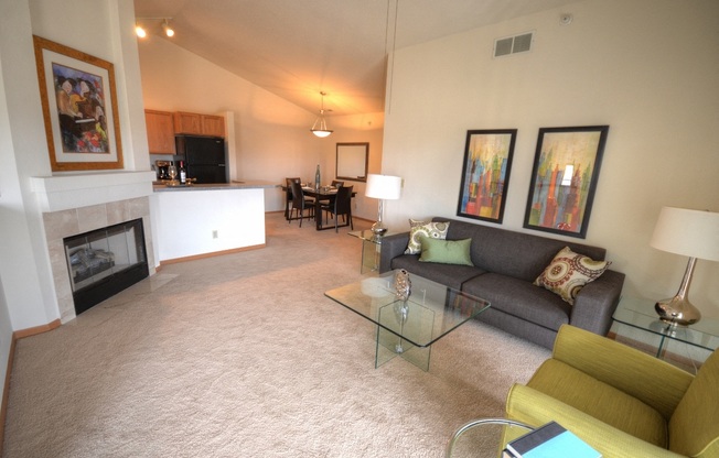 a living room with a couch and a table and a fireplace