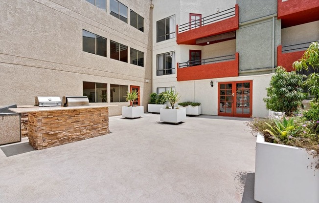 North Hollywood, CA Apartments for Rent - Woodland Trio - Built-In Grill, Planted Shrubs, and Outdoor Seating Area