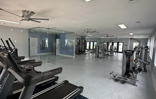 a gym with treadmills and other exercise equipment in a building