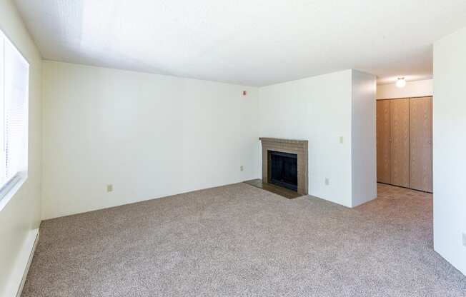 a living room with white walls and a fireplace