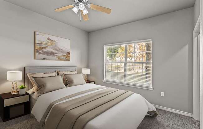 A bedroom with a large bed and a ceiling fan.