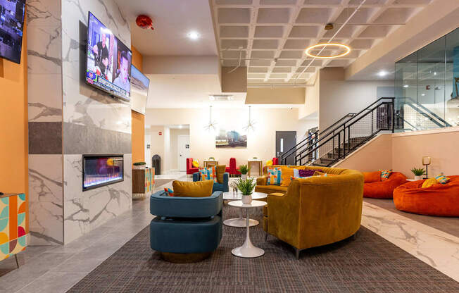 a lobby with couches and chairs and a television