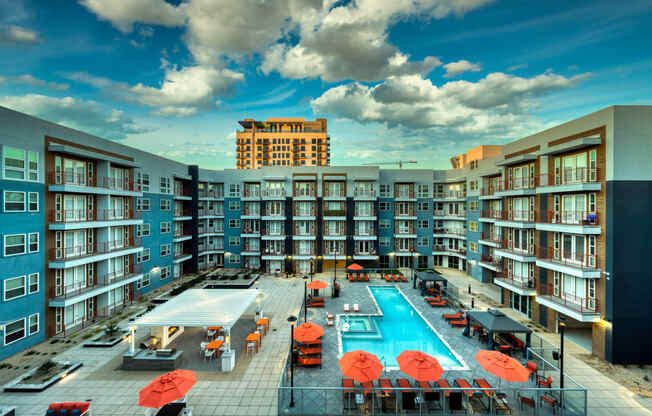 an overhead view of an apartment building with a swimming pool