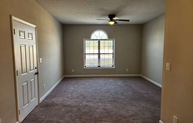 A room with a ceiling fan and a window with blinds. The Cloisters Apartments, 902 67th Avenue North, Myrtle Beach, SC