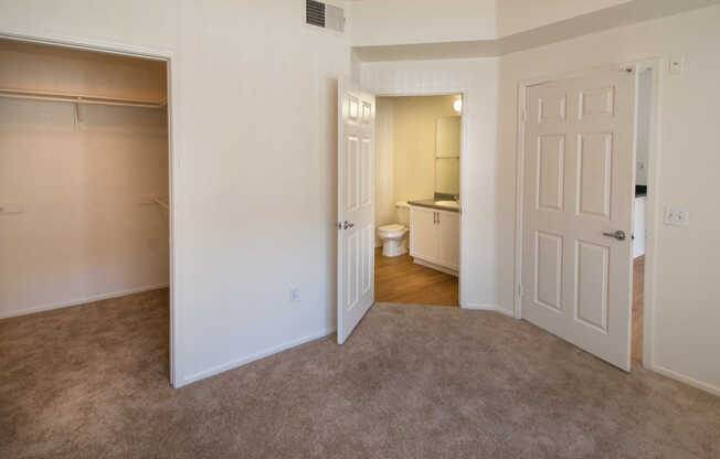 Carpeted Bedroom with Walk-In Closet and En Suite Bathroom
