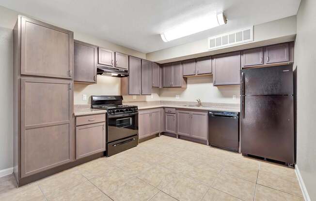 A kitchen with brown cabinets and appliances.