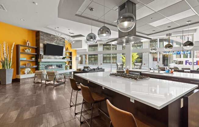 A modern kitchen with a long island and chairs.