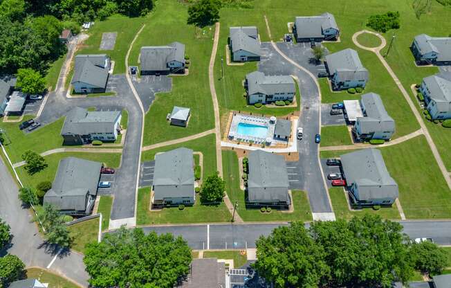 an aerial view of several mobile homes in a neighborhood with a swimming pool