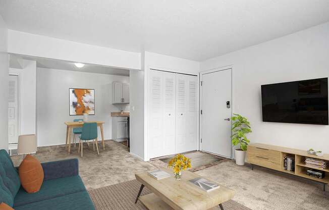 A living and dining room with plush carpeting at Apple Ridge Apartments, Walker, MI