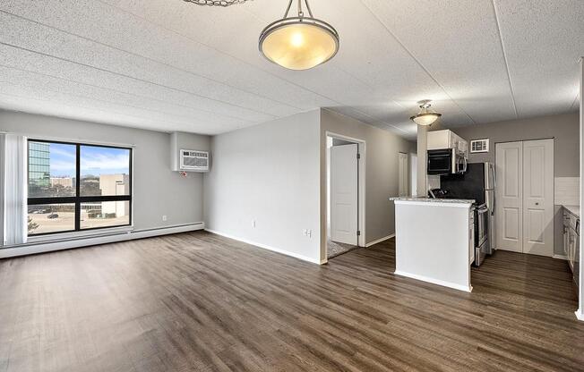 the living room and kitchen of an empty apartment at Troy Place Apartments - Troy, MI, Troy, Michigan