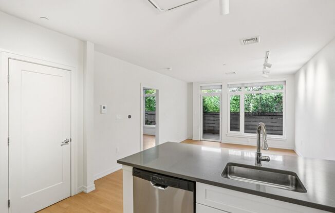 Kitchen with sink and dishwasher at Park77 Apartments, Cambridge, Massachusetts