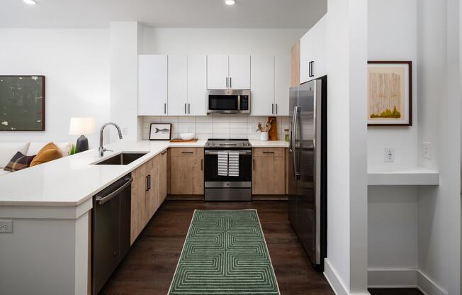 a kitchen with white cabinets and stainless steel appliances