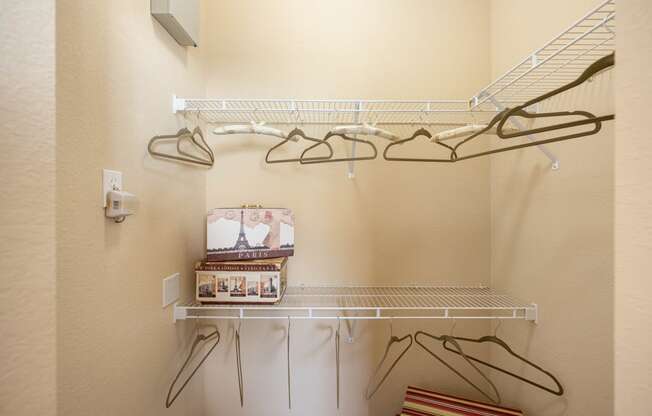 A walk in closet with shelving