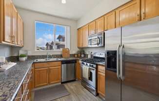 a kitchen with stainless steel appliances and wooden cabinets