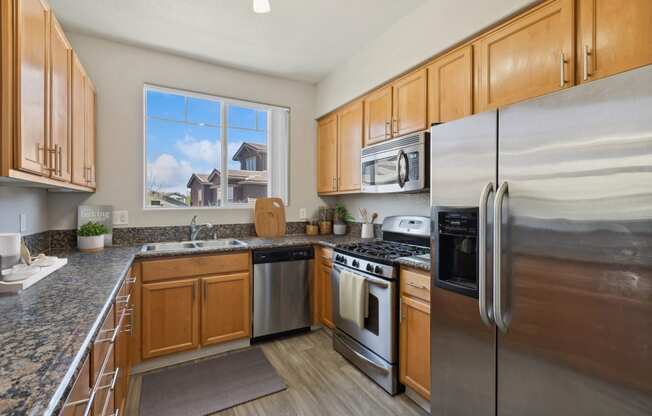 a kitchen with stainless steel appliances and wooden cabinets