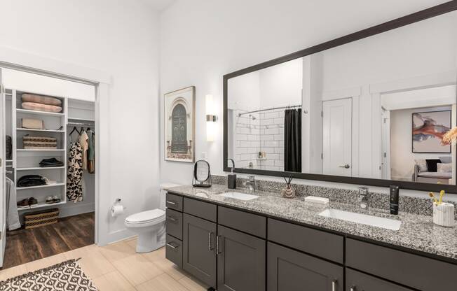 a bathroom with two sinks and a large mirror at The Colony, Charlotte, NC