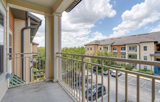 the view of the parking lot from the balcony of a apartment building