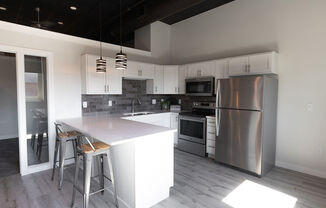 a kitchen with stainless steel appliances and a white counter top