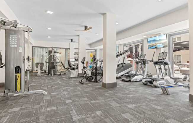 A gym with a variety of exercise equipment and a treadmill.