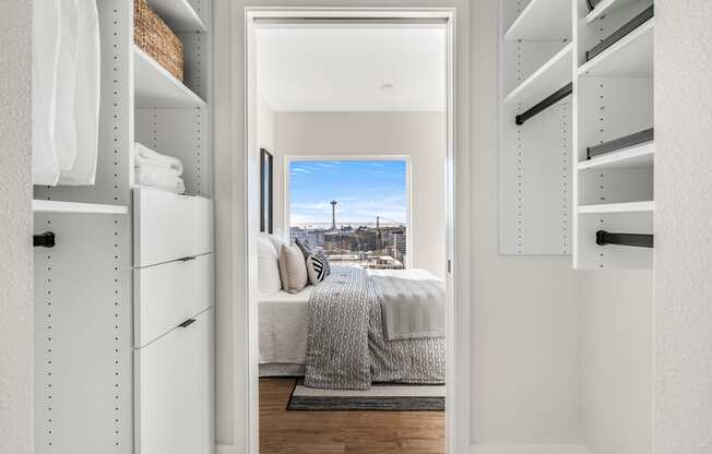 a walk in closet with a bed and a city view  at Oslo, Seattle, Washington