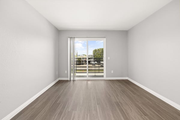 an empty living room with a door to a balconyat NOHO GALLERY Apartments, North Hollywood 