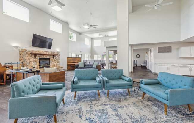 the preserve at ballantyne commons community living room with blue chairs and a fireplace