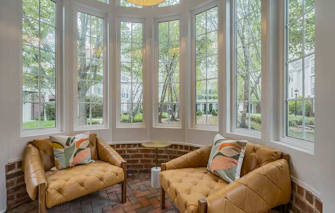 a living room with two couches and a row of windows