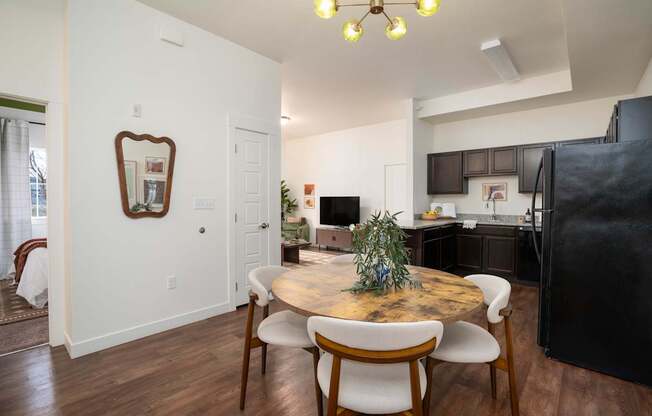 A dining room with a wooden table and chairs.