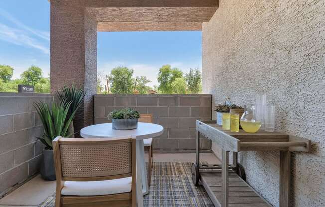 a patio with a table and chairs and a large window at Weylyn Luxury Apartments, Laveen, 85339