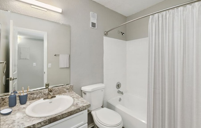 a bathroom with a sink toilet and bathtub