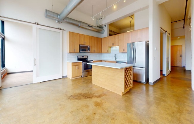 a large kitchen with wood cabinets and stainless steel appliances