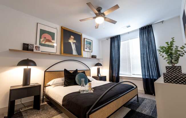 a bedroom with a large bed and a ceiling fan