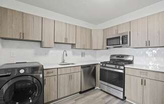 Skyline Towers apartments kitchen with wood cabinets and stainless kitchen appliances