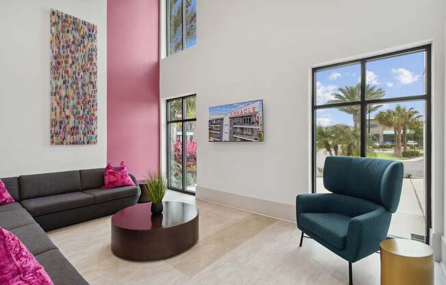 A living room with a grey sofa, a green armchair, and a coffee table.