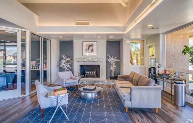 a living room with couches and chairs and a fireplace